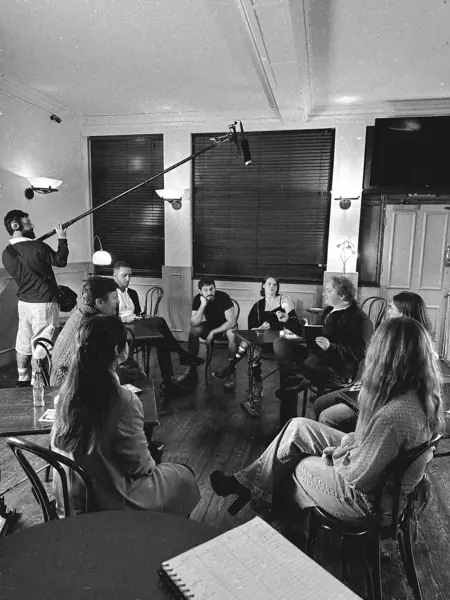Cast rehearsing around a pub table with the sound crew
