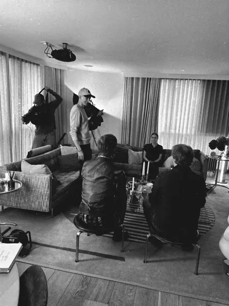 Filming a scene around the living room table